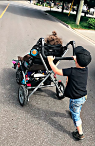 Trinity and her brother Cooper walking together. Habitat is working to build more accessible homes for families like the Leonards