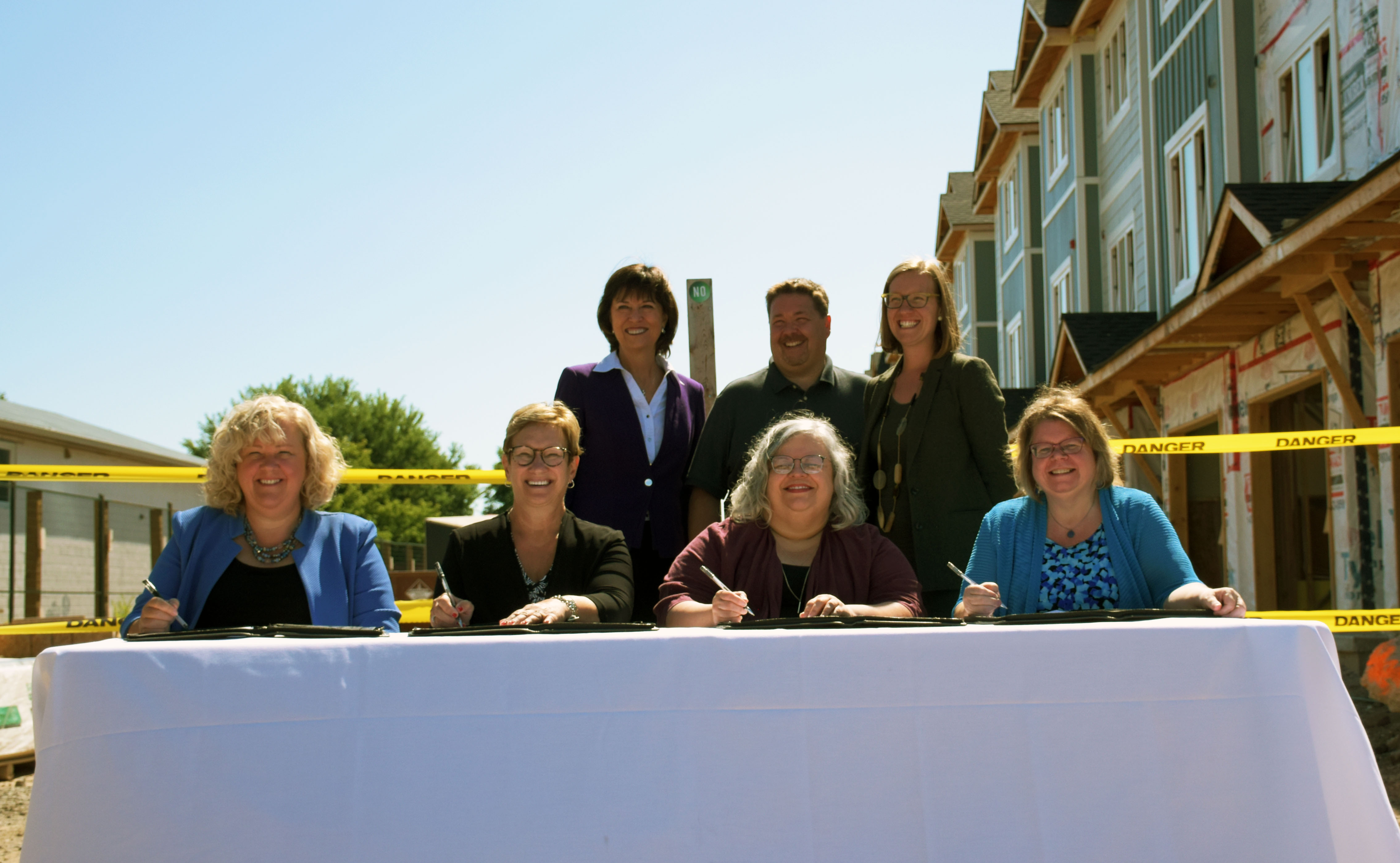 Back row (left to right): Pam Damoff, MP Oakville North-Burlington, John Gerrard, CEO Habitat HM, and Karina Gould, MP Burlington. Front row (left to right): Kim Jenkinson, Halton Multicultural Council; Diane Beaulieu, Halton Women’s Place; Irene Zivko, Summit Housing & Outreach Programs, and Donna Danielli, Milton Transitional Housing.