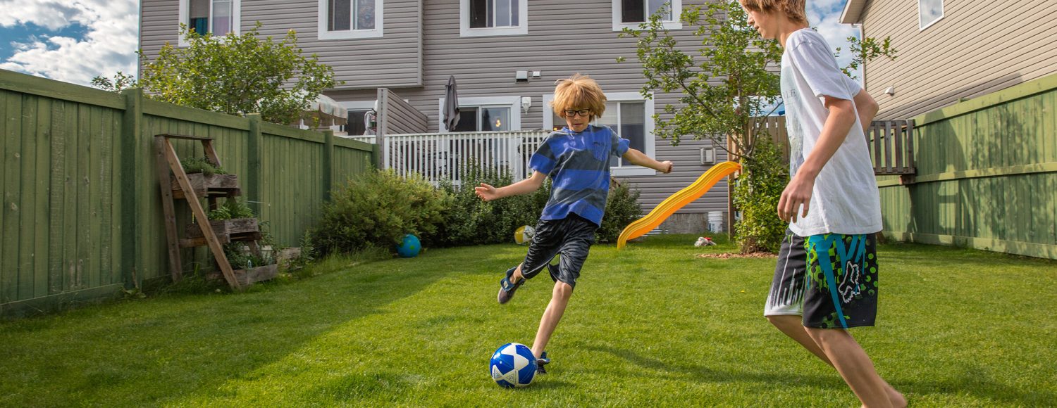SHERWOOD PARK, ALBERTA, CANADA (6/30/16)-Cindy Kostelyk lives in a Habitat home outside Edmonton with her children Justin (14, white shirt), Tyler (11, blue striped shirt) and Megan (9).  © Habitat for Humanity International/Ezra Millstein